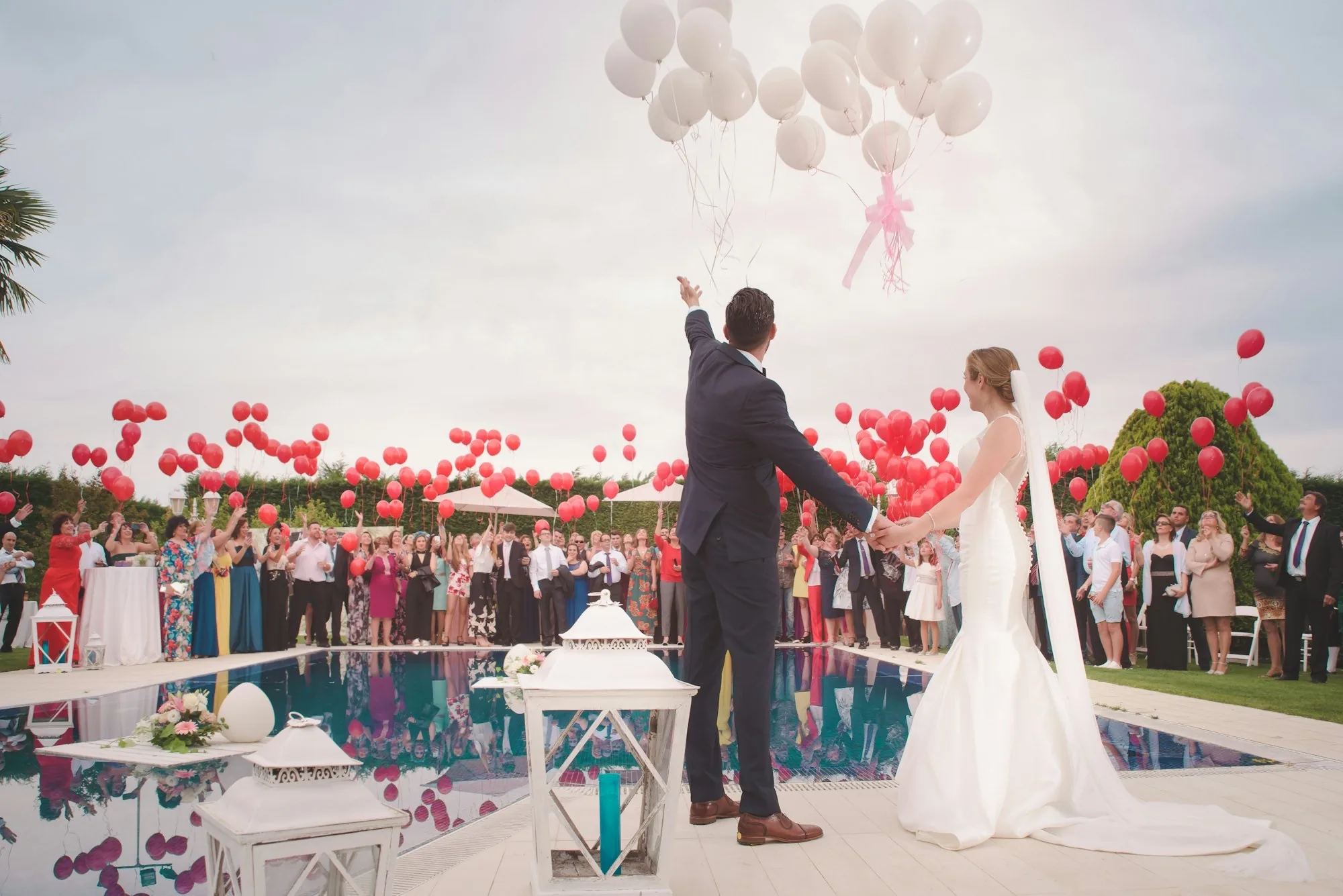 Outdoor wedding ceremony with guests and aisle florals